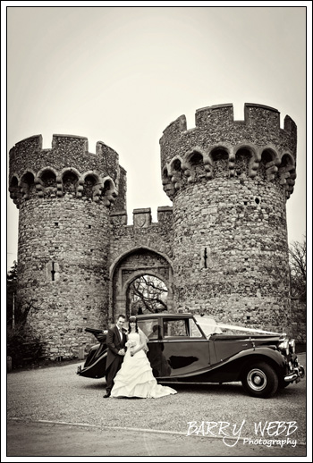 Posing in front of the castle at Castle Cooling Barn in Kent - Wedding Photography